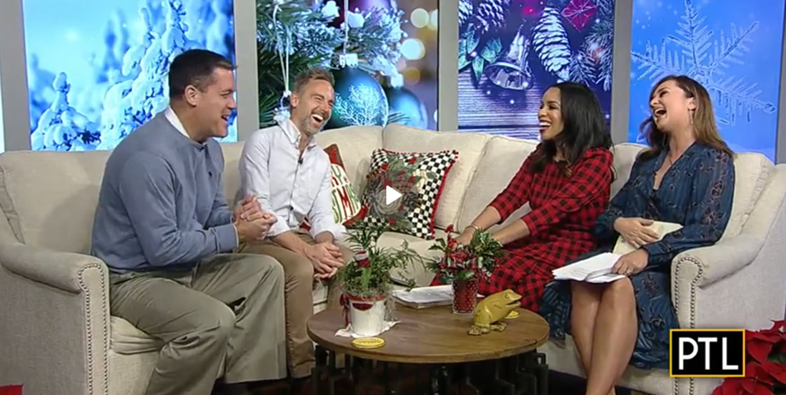 Behr and Rydzewski sit and laugh with CBS News PTL hosts on comfortable couches in a cozy, winter-themed studio.